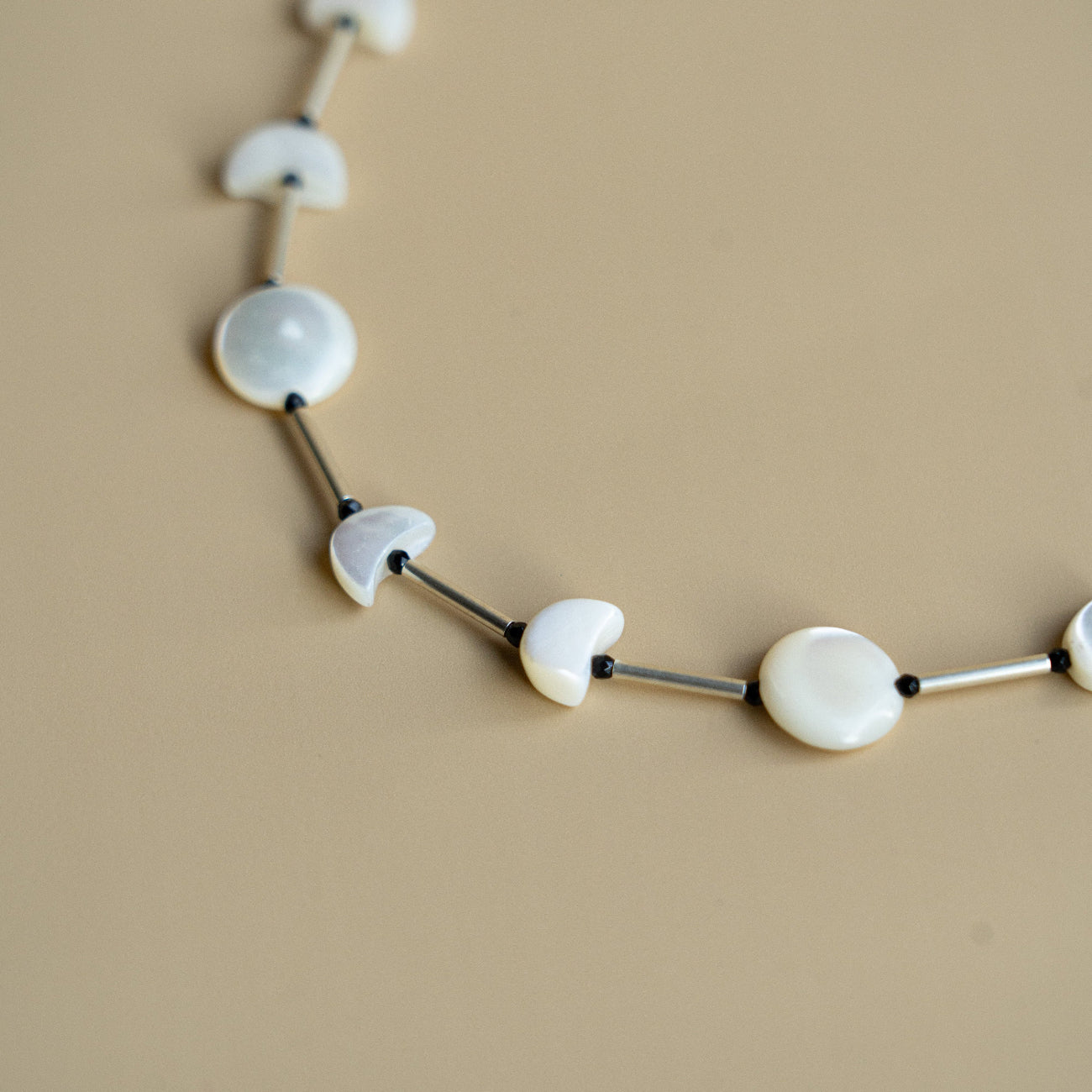 Melanie Decourcey Full moon/half moon mother of pearl alternating with silver tube and onyx