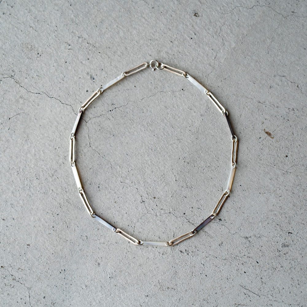 Melanie Decourcey Black/White mother of pearl with Oval silver links necklace