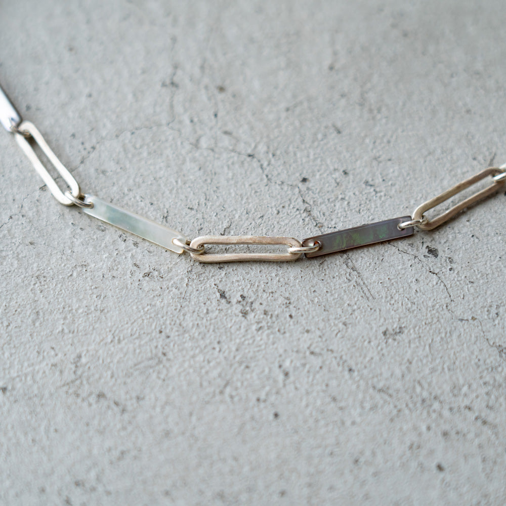 Melanie Decourcey Black/White mother of pearl with Oval silver links necklace