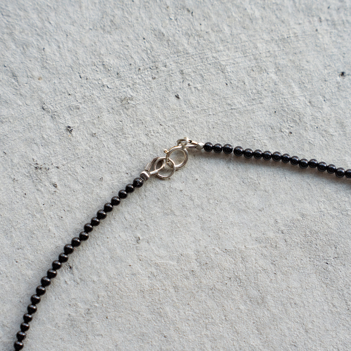 Melanie DeCourcey Small black onyx with long pearl center