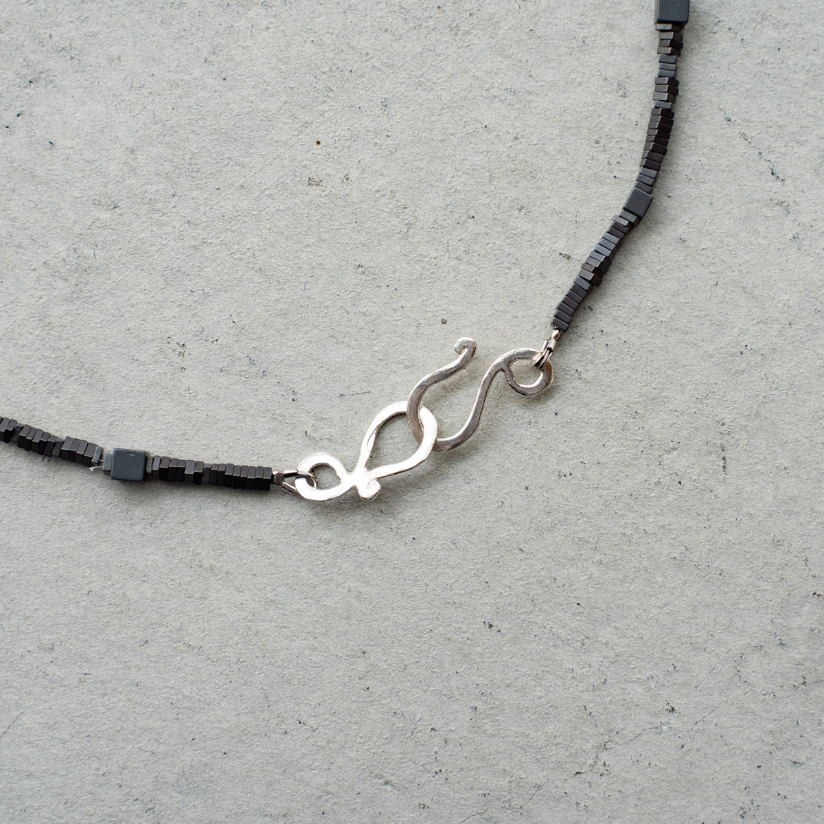 Melanie DeCourcey Different shape Hematite with pearl center