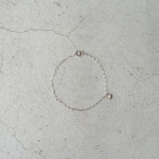 Melanie DeCourcey  Heart shape silver chain with small floating black mother of pearl heart
