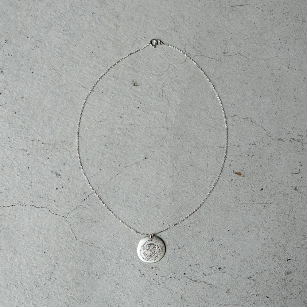 Melanie DeCourcey Round silver pendant with scribbles