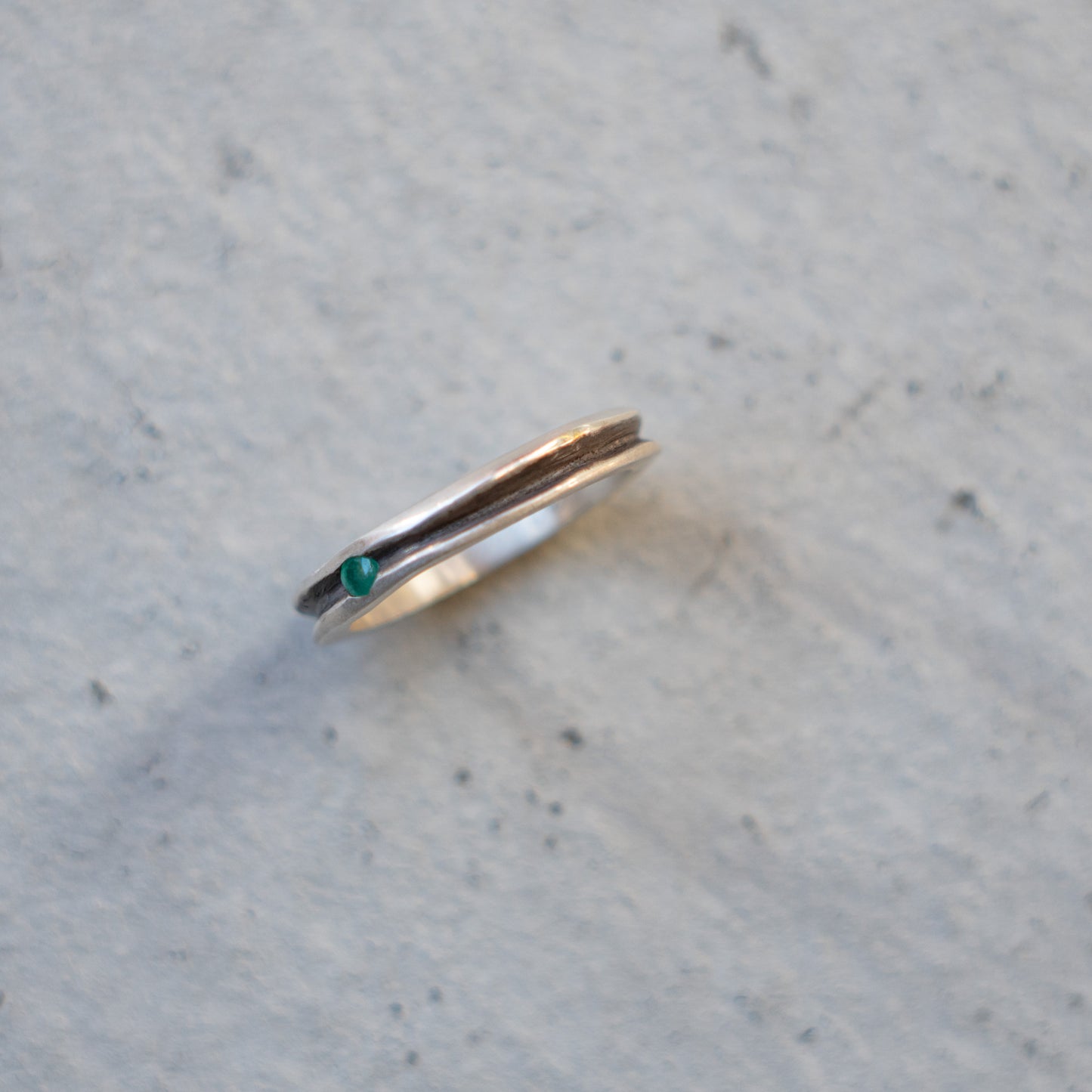Melanie Decourcey Thin silver ring with oxidized groove and emerald