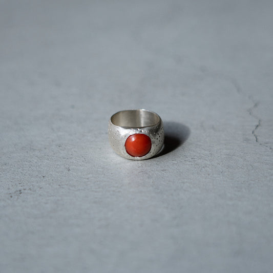 Melanie Decourcey  Silver ring with dot texture and round coral center