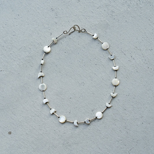 Melanie Decourcey  Full moon/half moon mother of pearl alternating with silver tube and onyx