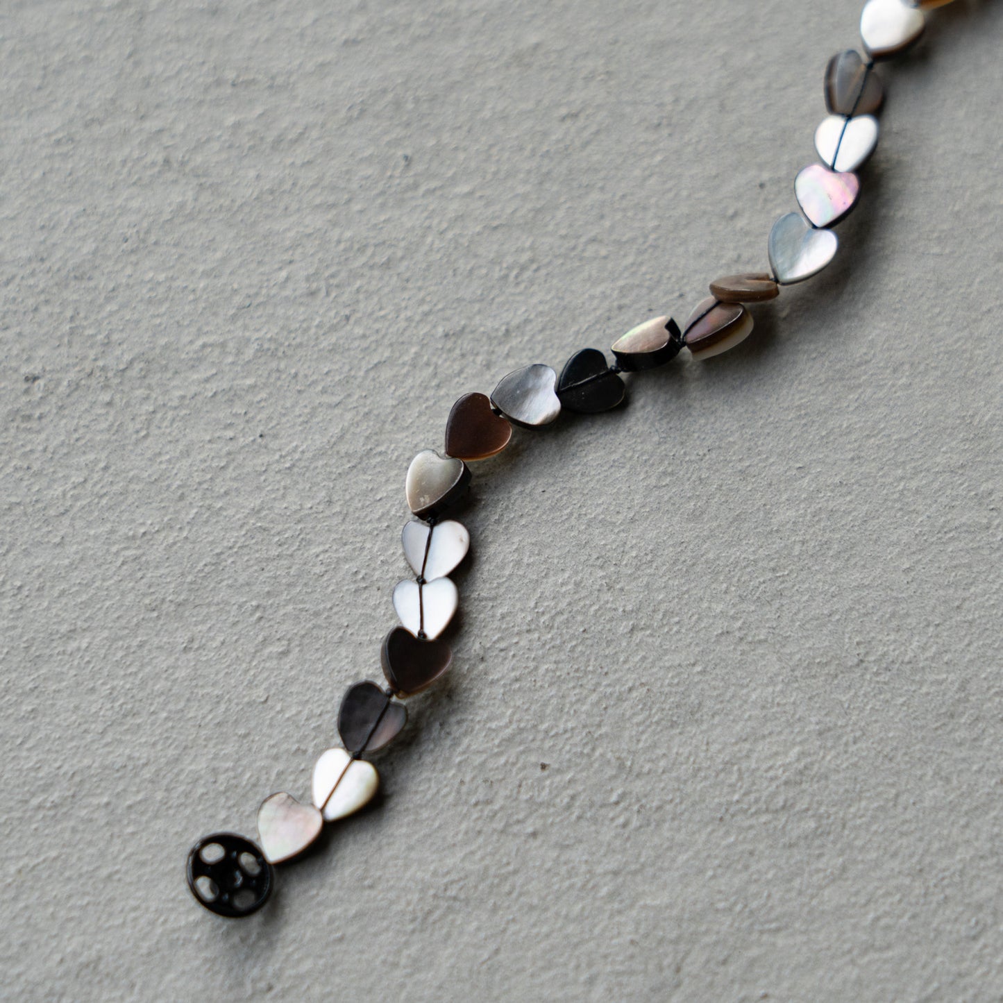 Melanie Decourcey  Black mother of pearl heart shaped beads DNA bracelet