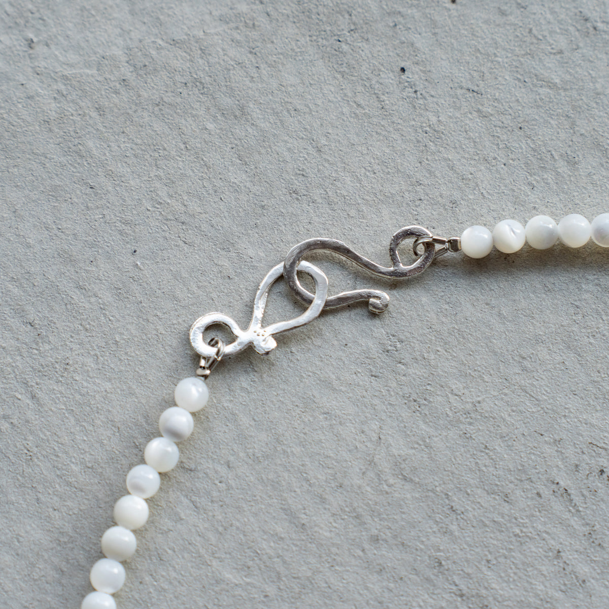 Melanie DeCourcey   Mother of pearl with silver tubes and mother of pearl moon shape