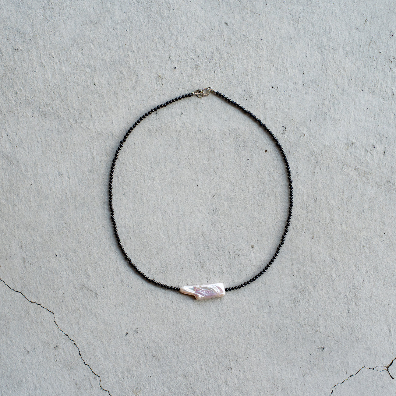 Melanie DeCourcey   Small black onyx with long pearl center