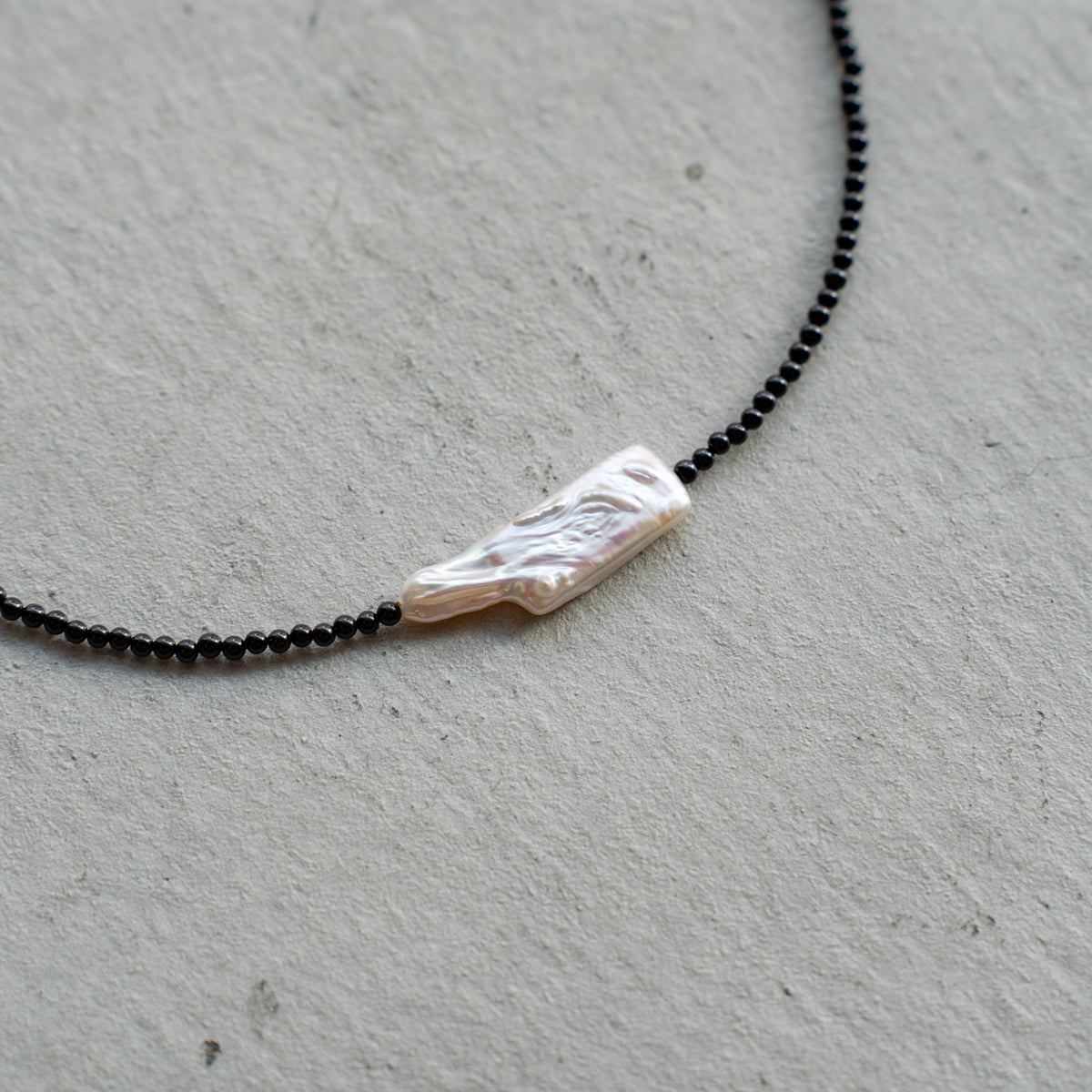 Melanie DeCourcey   Small black onyx with long pearl center