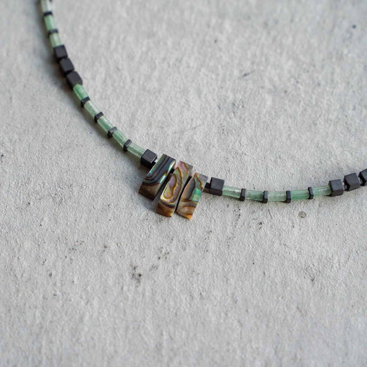 Melanie DeCourcey   Aventurine alternating with hematite and Abalone shell cennter