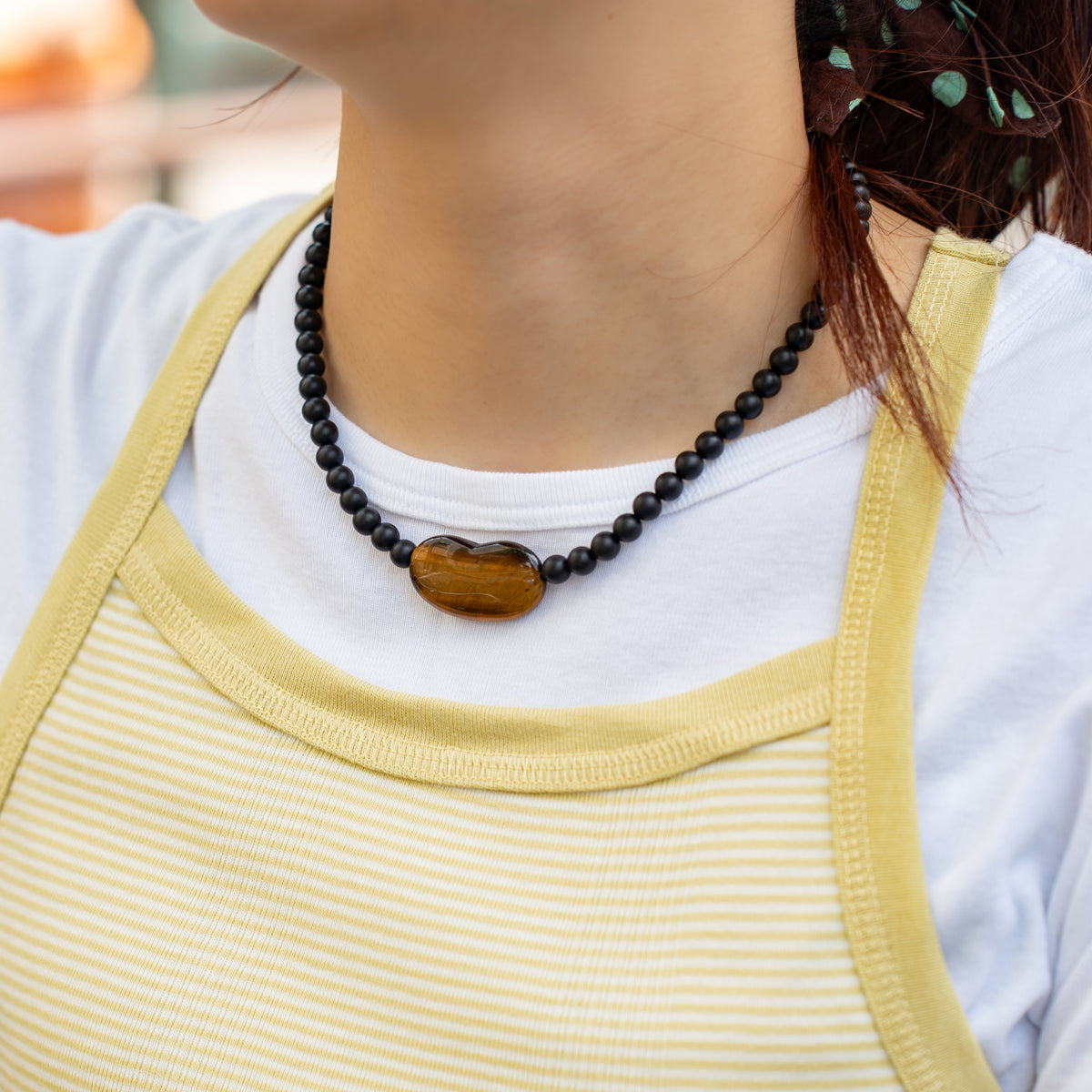 Melanie DeCourcey   Matte onyx with tiger eye heart center