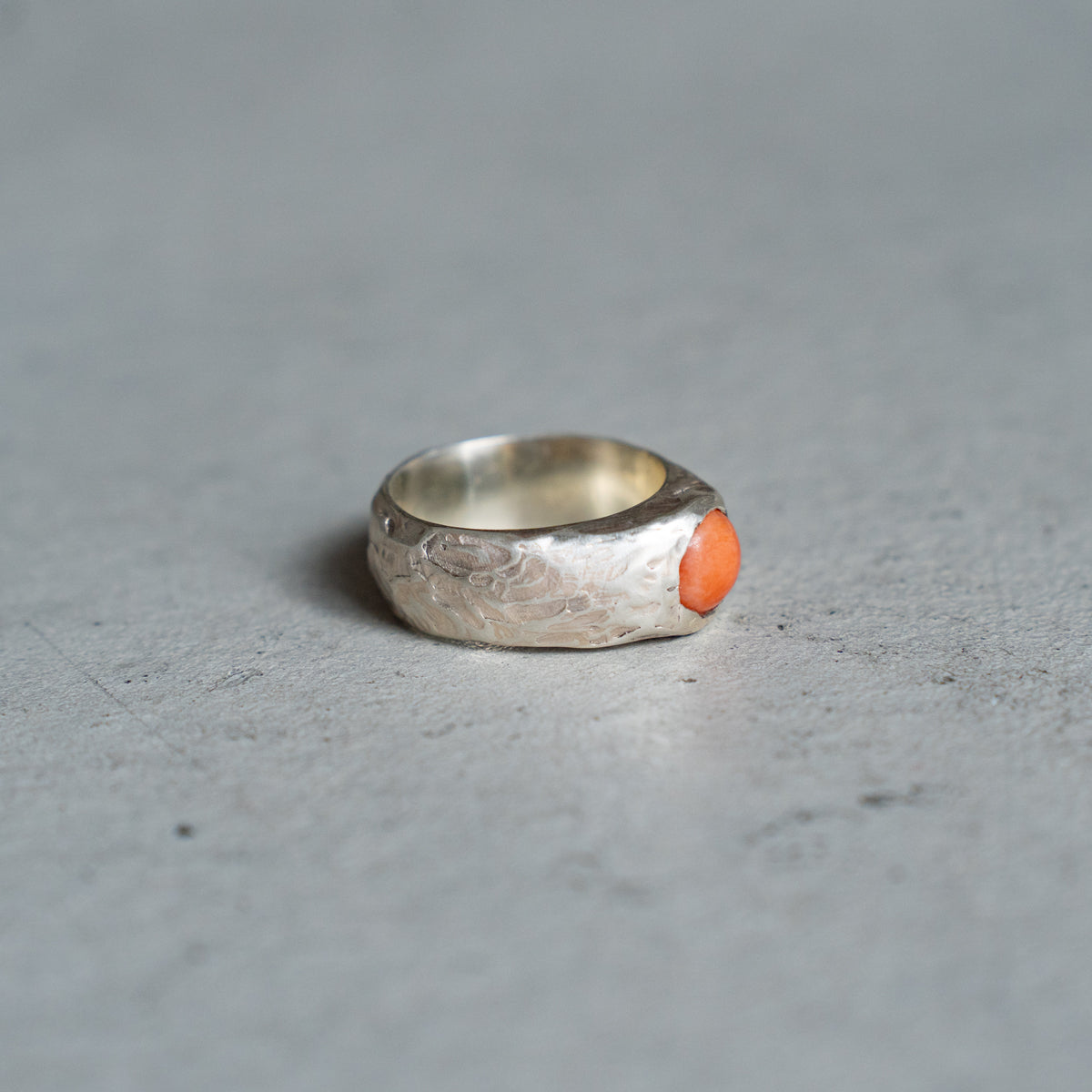 Melanie Decourcey  Textured silver ring with round coral