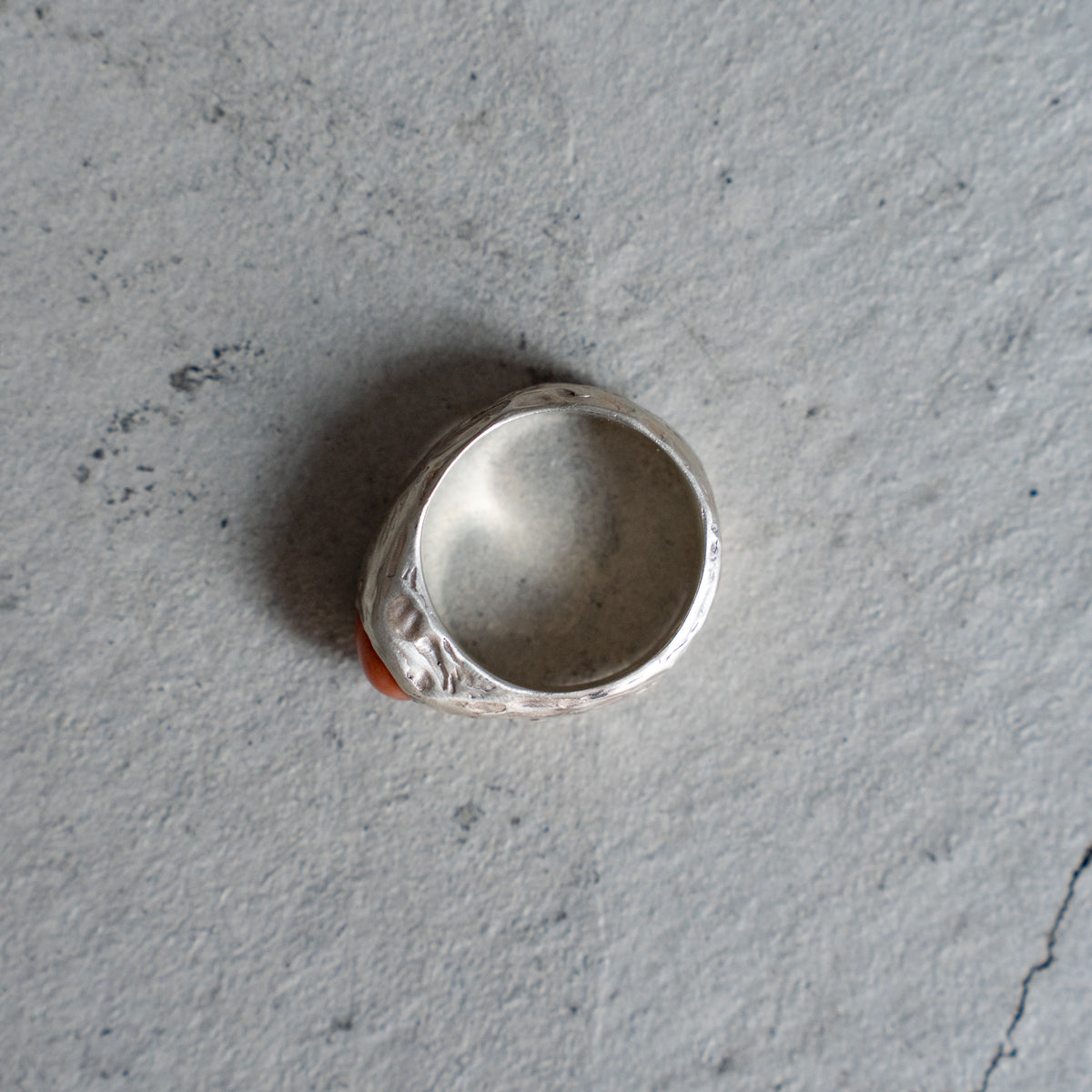 Melanie Decourcey  Textured silver ring with round coral