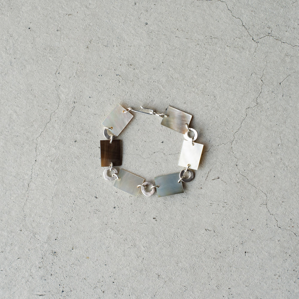 Melanie Decourcey  Square mother of pearl and round silver parts bracelet