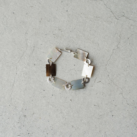 Melanie Decourcey  Square mother of pearl and round silver parts bracelet