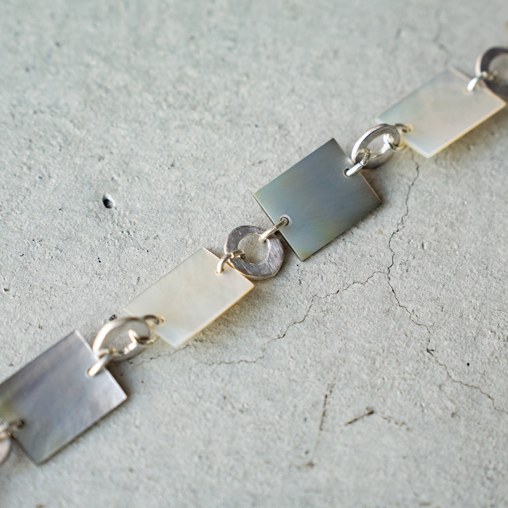 Melanie Decourcey  Square mother of pearl and round silver parts bracelet