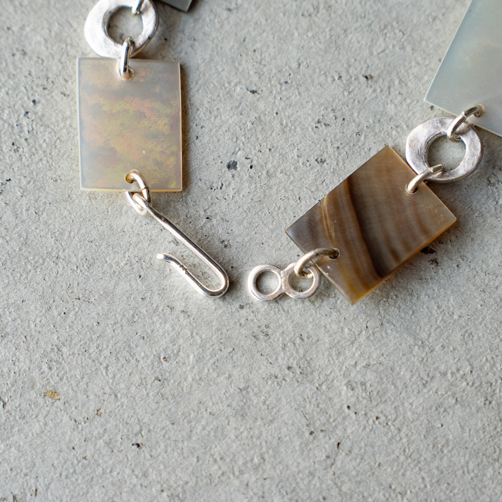 Melanie Decourcey  Square mother of pearl and round silver parts bracelet