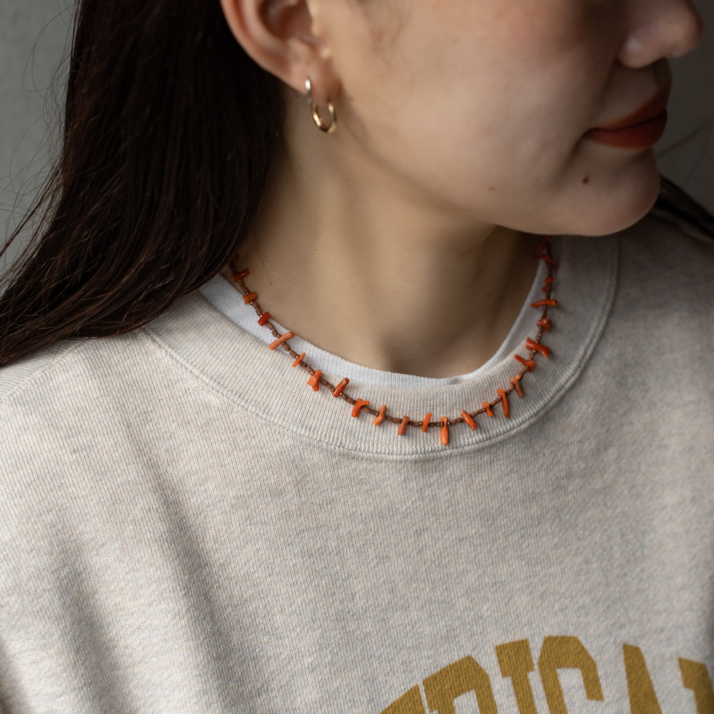 Melanie DeCourcey   Beaded necklace  -antique natural coral, African terracotta beads with tiny copper detail