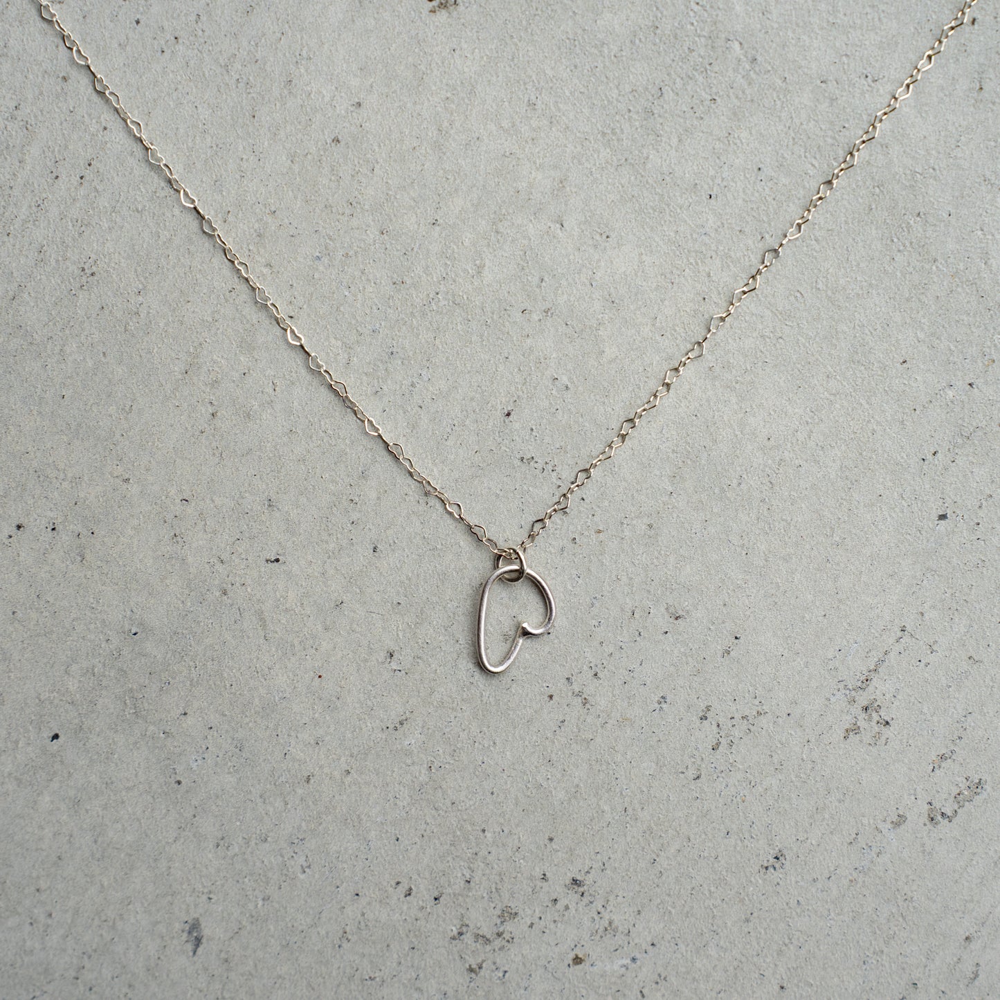 Melanie DeCourcey  Heart shaped silver chain with freestyle pendant