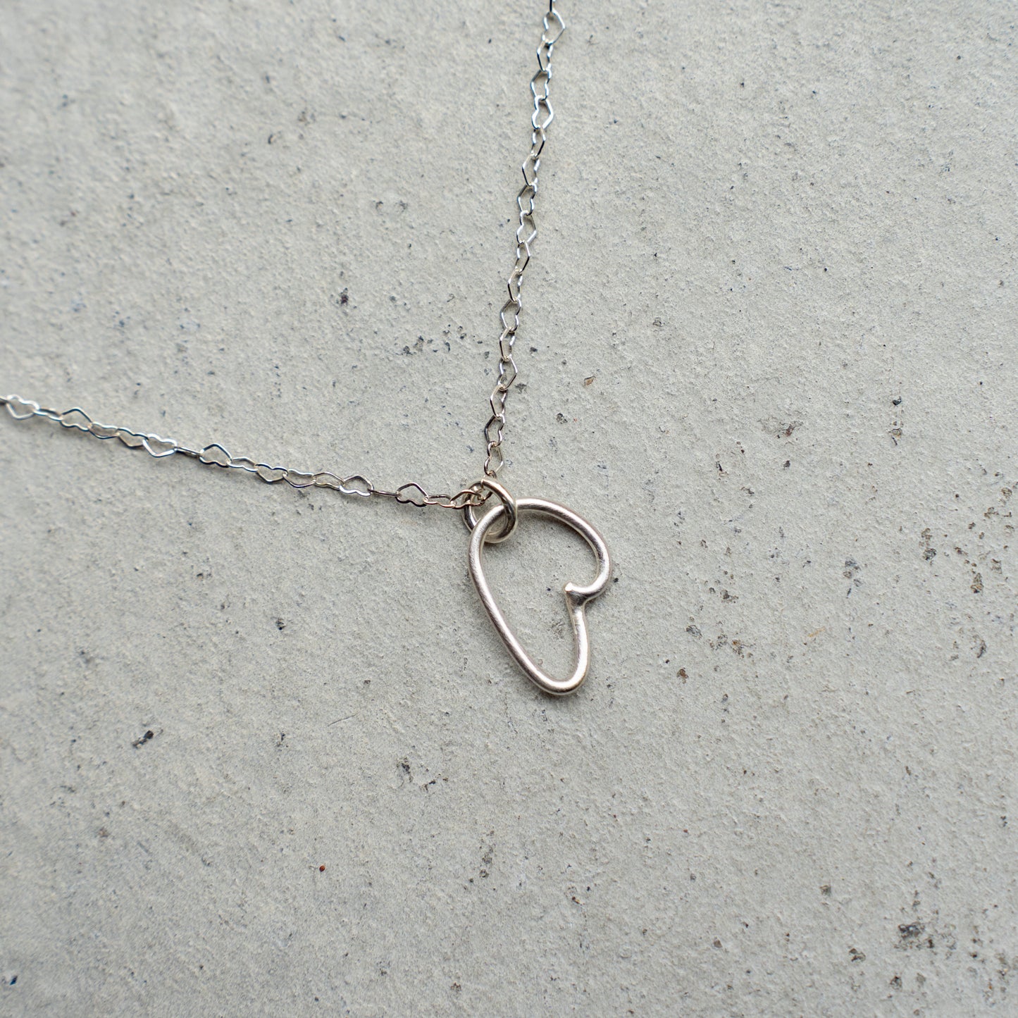 Melanie DeCourcey  Heart shaped silver chain with freestyle pendant
