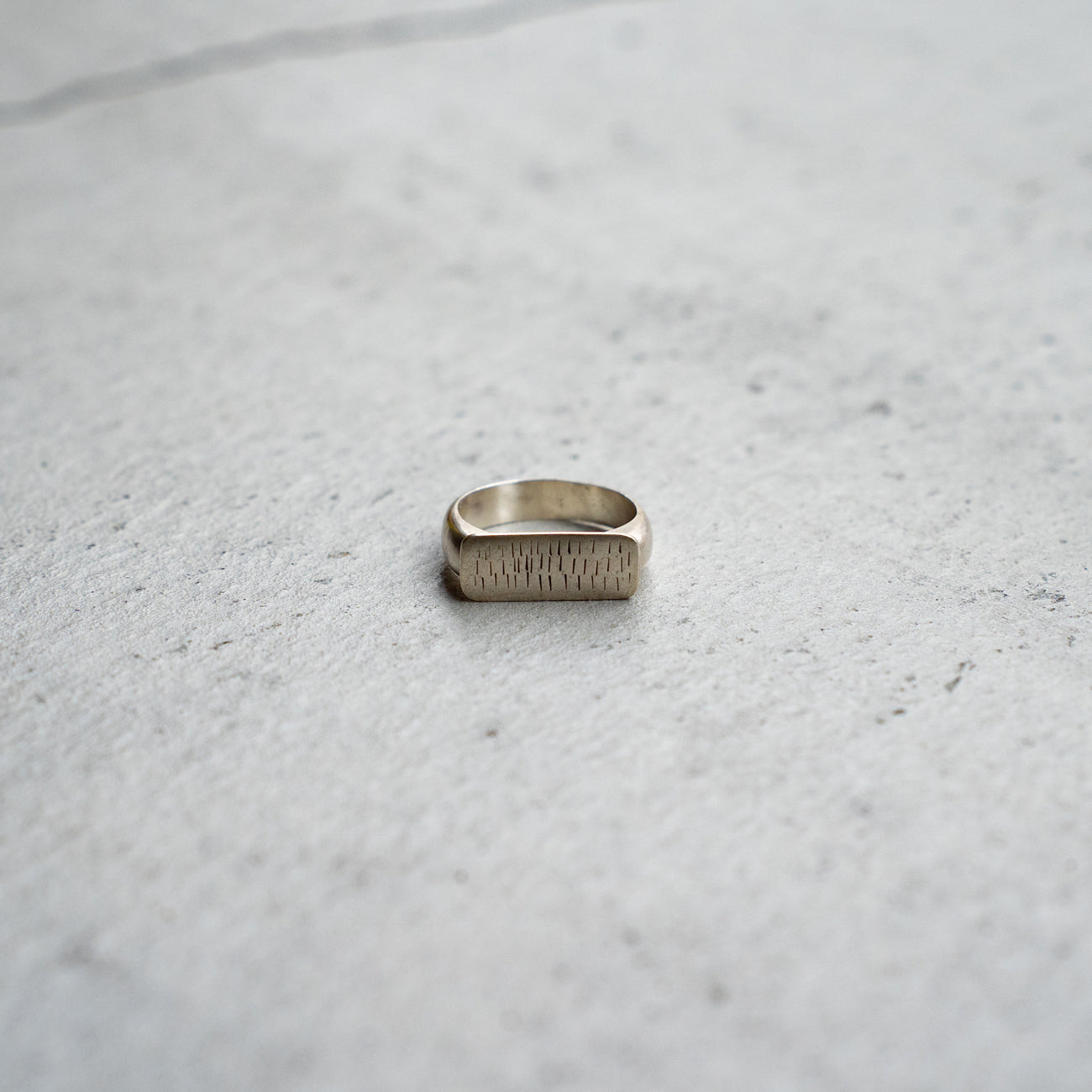 Melanie Decourcey  Silver ring with multiple vertical lines