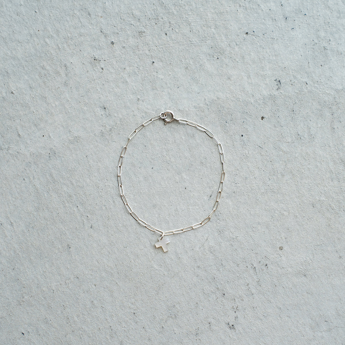 Melanie DeCourcey  Silver chain with small white mother of pearl cross