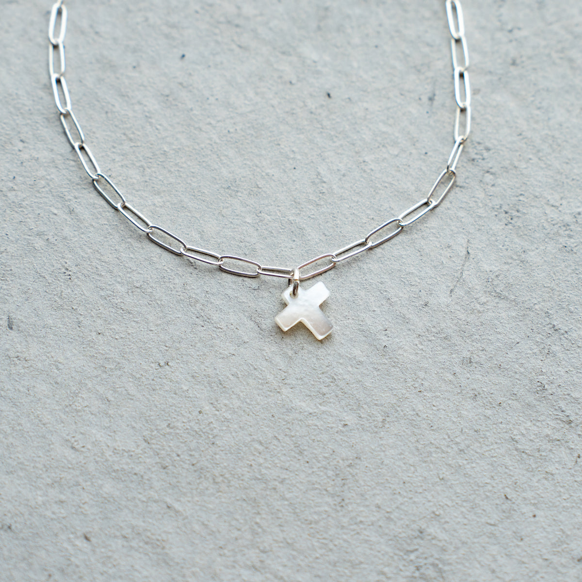 Melanie DeCourcey  Silver chain with small white mother of pearl cross
