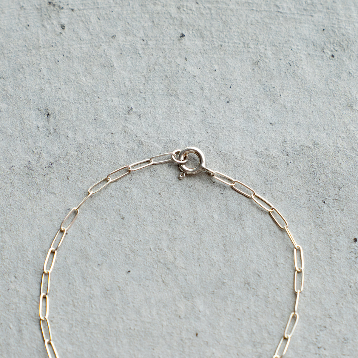 Melanie DeCourcey  Silver chain with small white mother of pearl cross