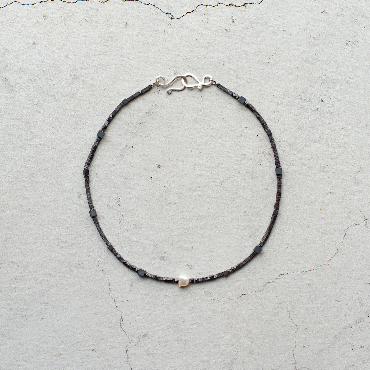 Melanie DeCourcey   Different shape Hematite with pearl center