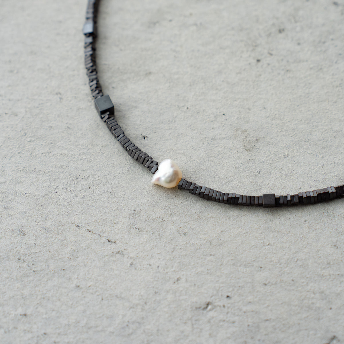 Melanie DeCourcey   Different shape Hematite with pearl center