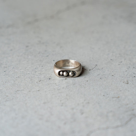 Melanie Decourcey  Silver ring with 3 freestyle silver balls inside oxidized center