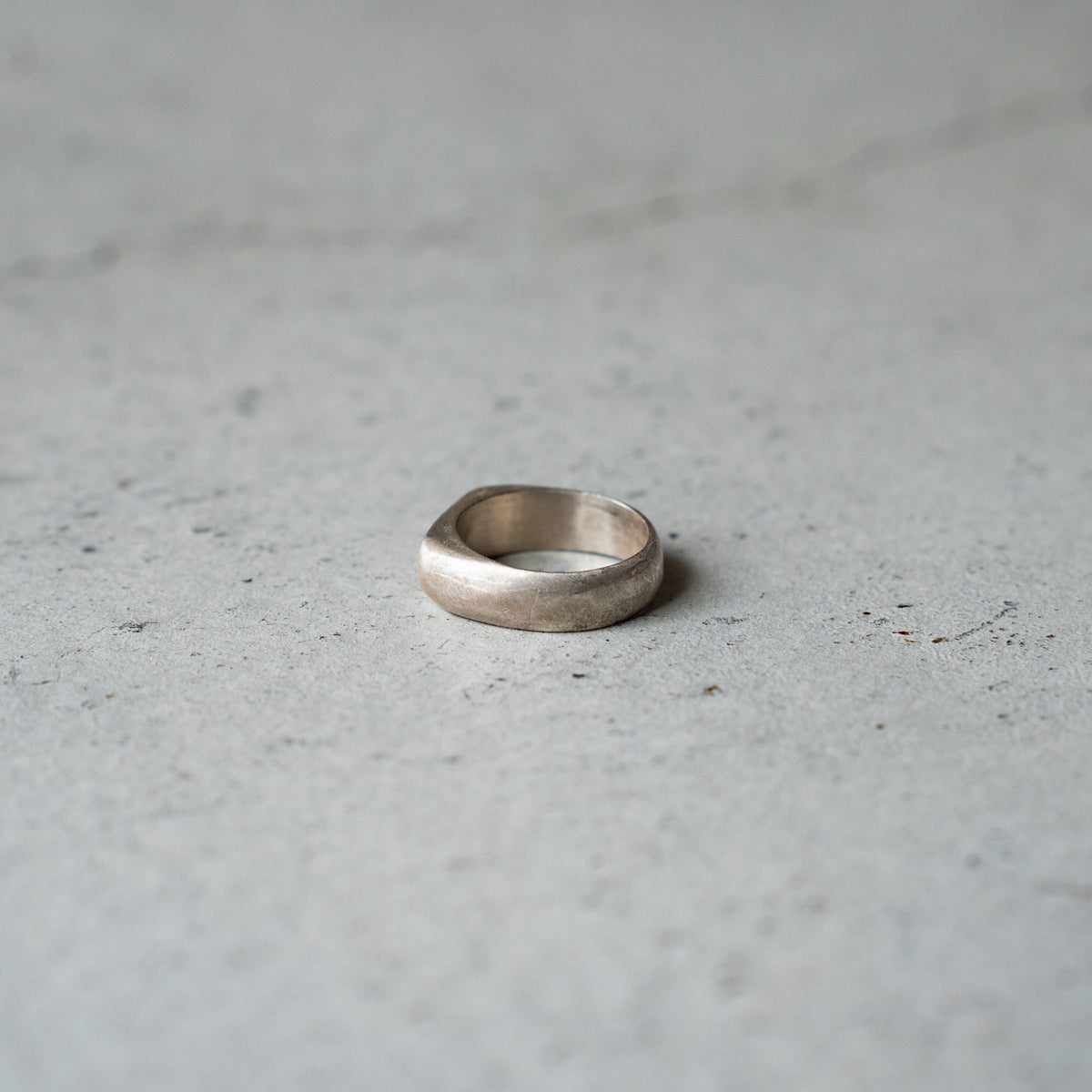 Melanie Decourcey  Silver ring with 3 freestyle silver balls inside oxidized center