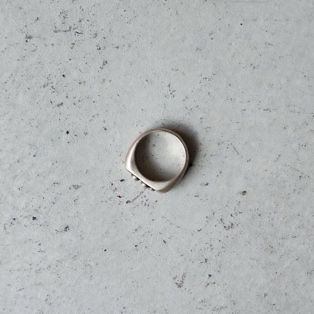 Melanie Decourcey  Silver ring with 3 freestyle silver balls inside oxidized center