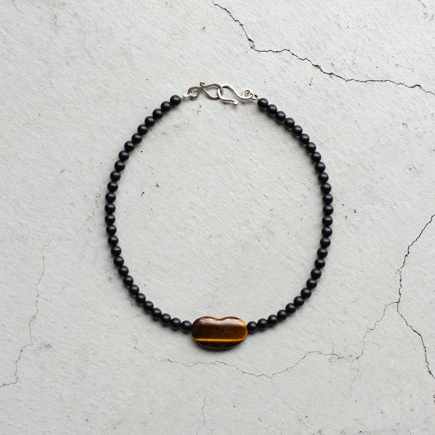Melanie DeCourcey   Matte onyx with tiger eye heart center
