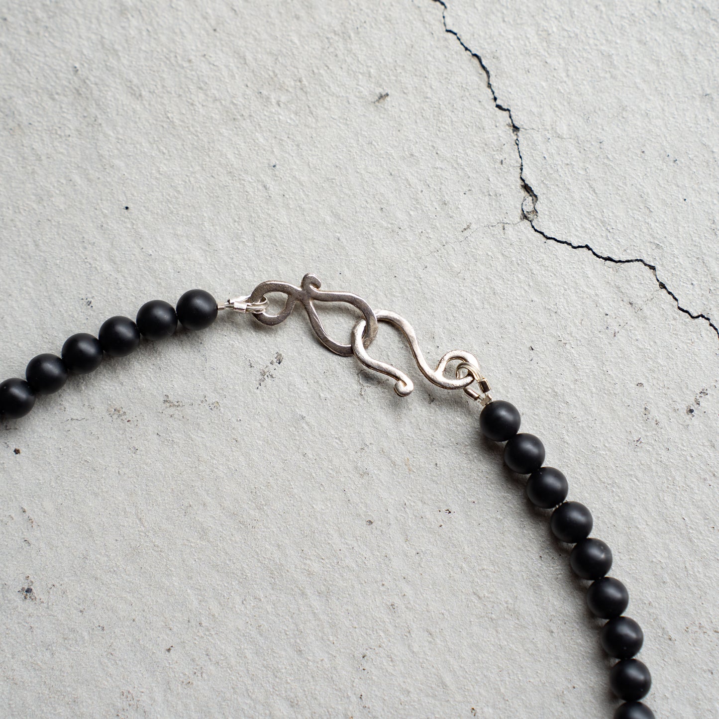 Melanie DeCourcey   Matte onyx with tiger eye heart center