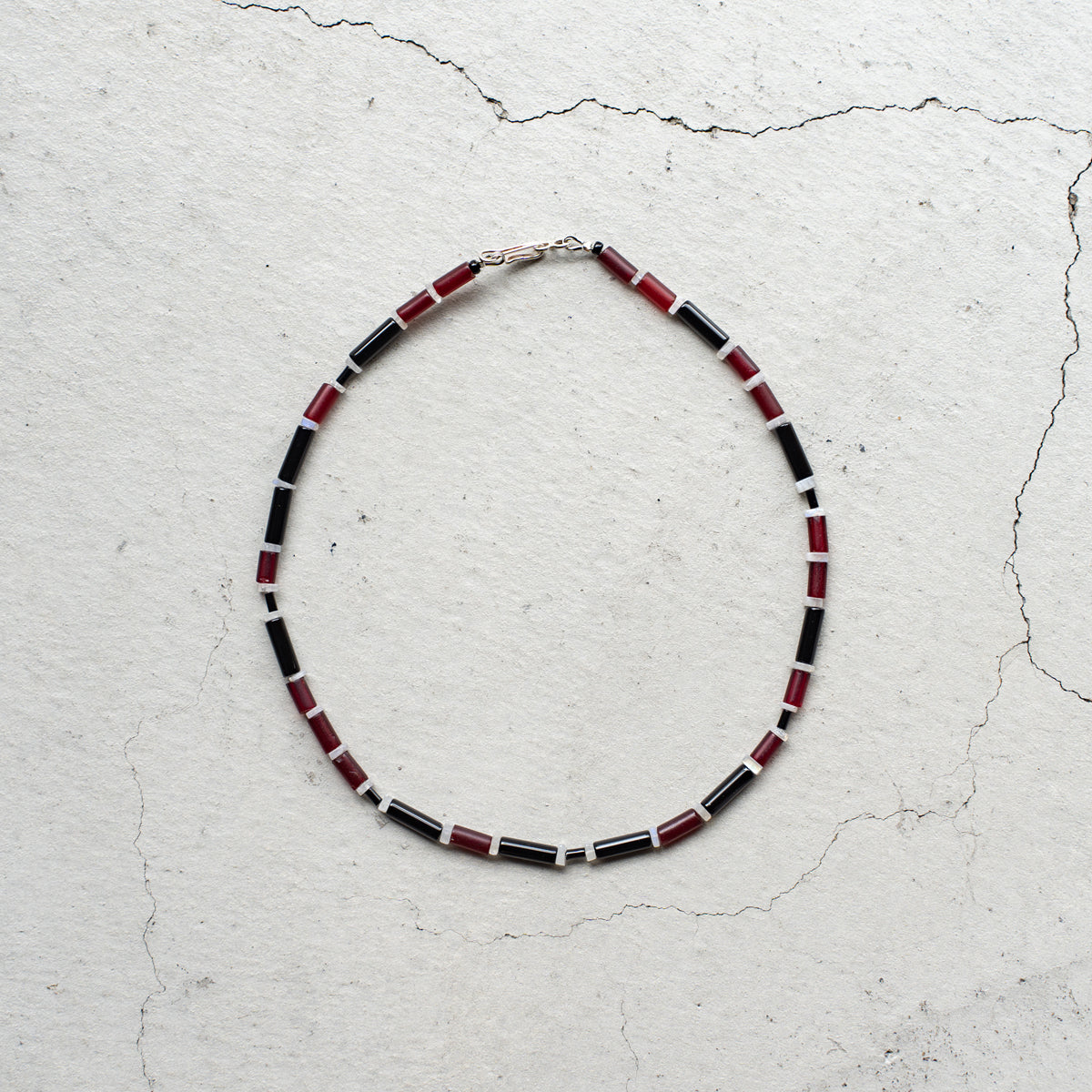 Melanie DeCourcey   Red African glass beads, onyx, moonstone
