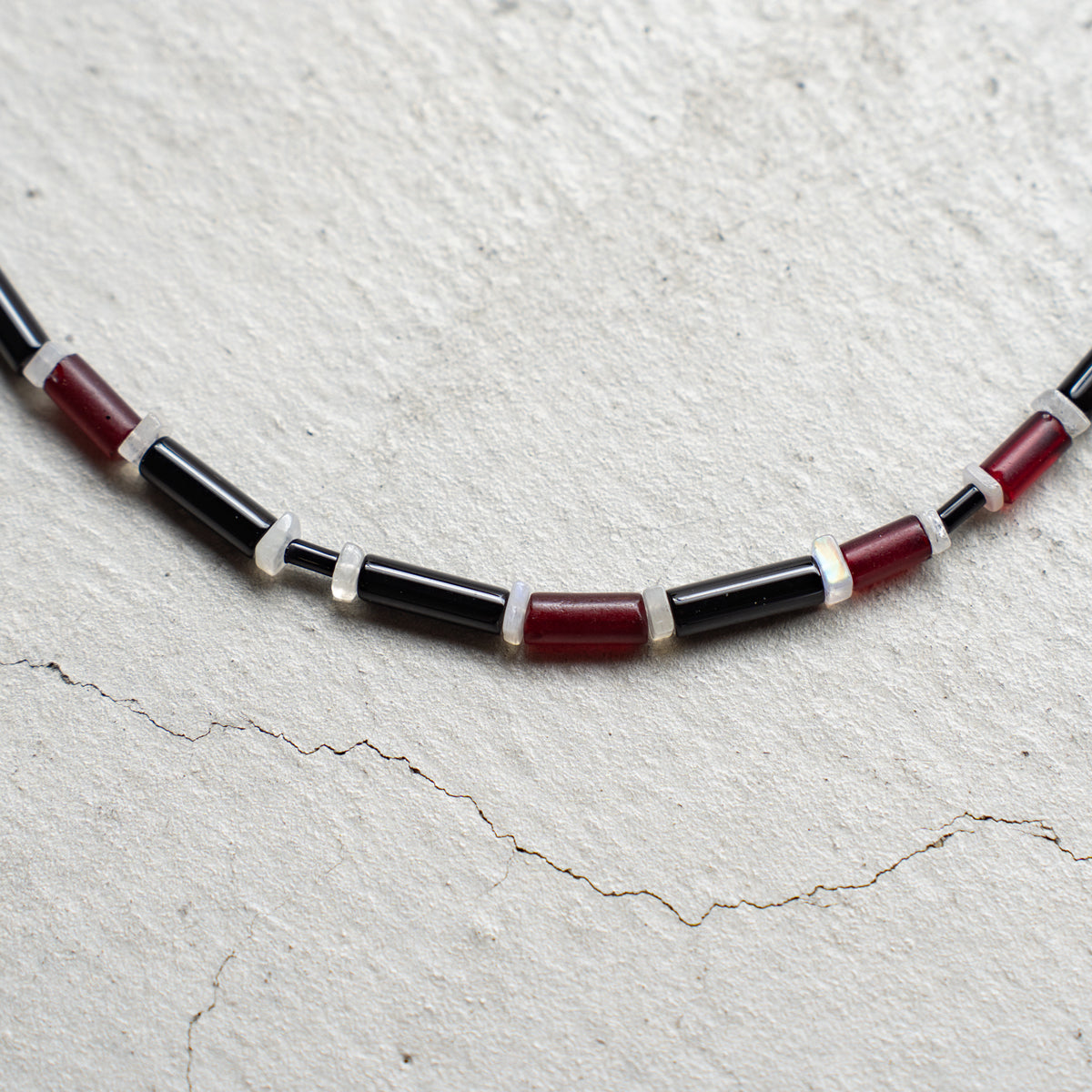 Melanie DeCourcey   Red African glass beads, onyx, moonstone