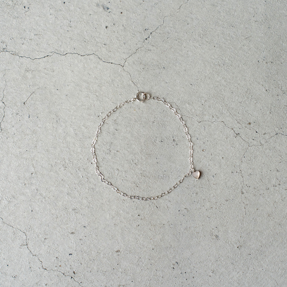 Melanie DeCourcey  Heart shape silver chain with small floating black mother of pearl heart