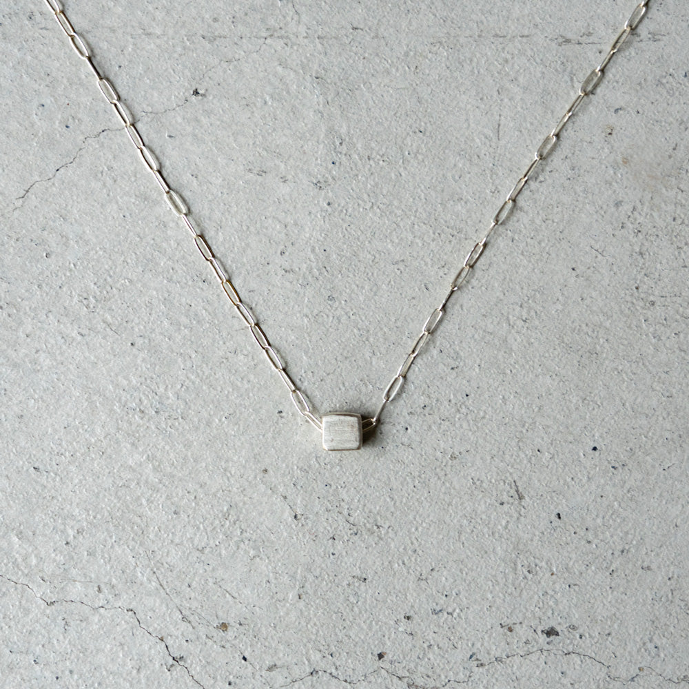Melanie DeCourcey   Silver cube on chain