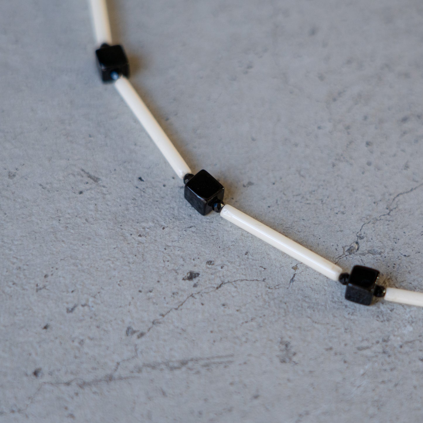 Melanie Decourcey  Ivory color glass tubes alternating with onyx cube