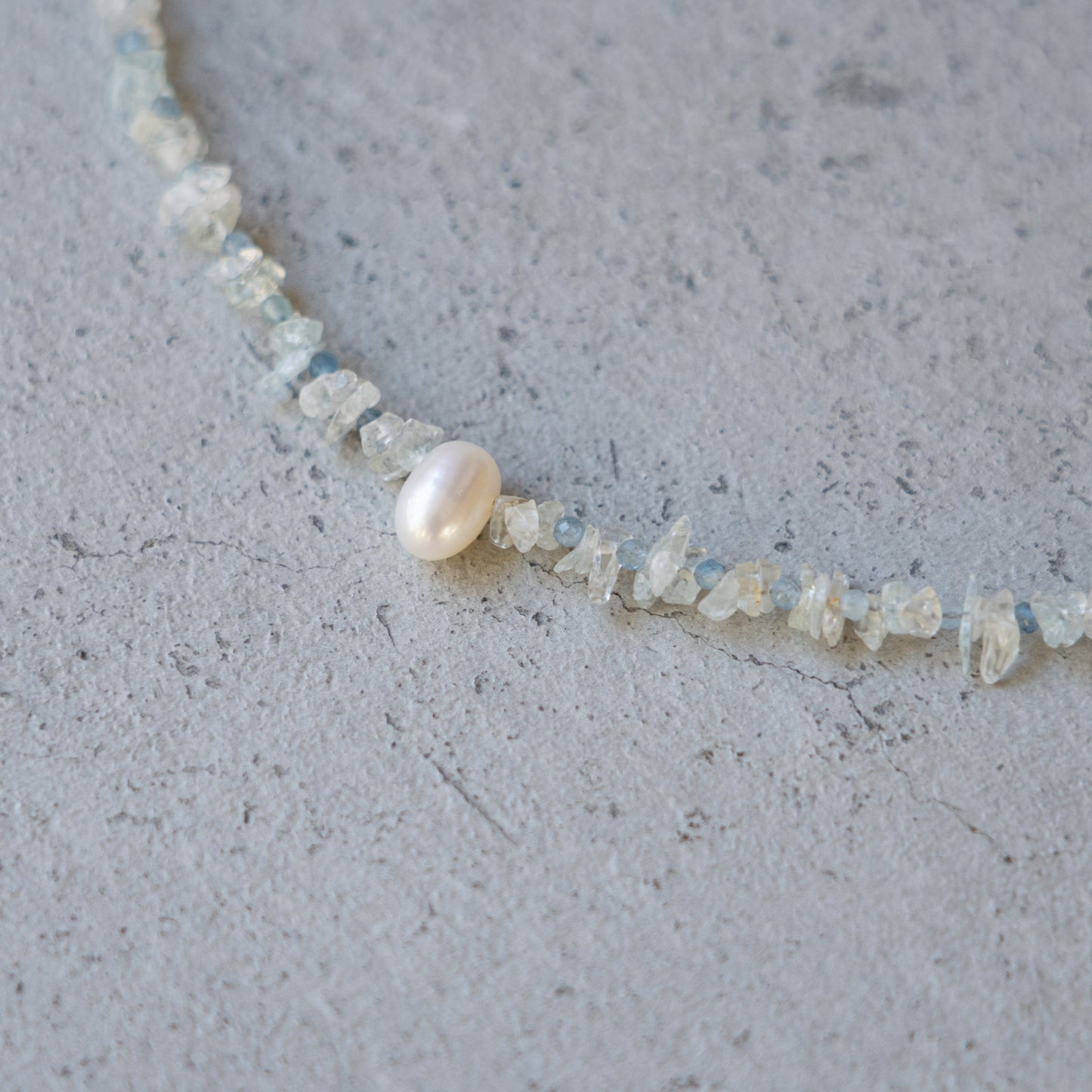 Melanie Decourcey  Aquamarine beads with pearl center